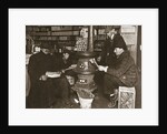 A group of men around a stove in a shop by Anonymous