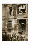 A crowd of men gathered in front of a ruined building by Anonymous