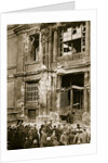 A crowd of men gathered in front of a ruined building by Anonymous