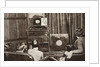 People watching an early television transmission by Anonymous