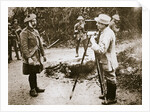 Cameraman filming a wounded soldier by Anonymous