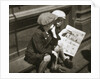 Two boys reading the comic section of the Sunday paper by Anonymous