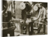 Money making; cutting strips of silver into disks by Anonymous