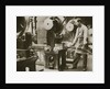 Money making; cutting strips of silver into disks by Anonymous