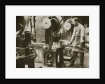 Money making; cutting strips of silver into disks by Anonymous