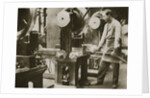 Money making; cutting strips of silver into disks by Anonymous