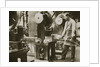 Money making; cutting strips of silver into disks by Anonymous