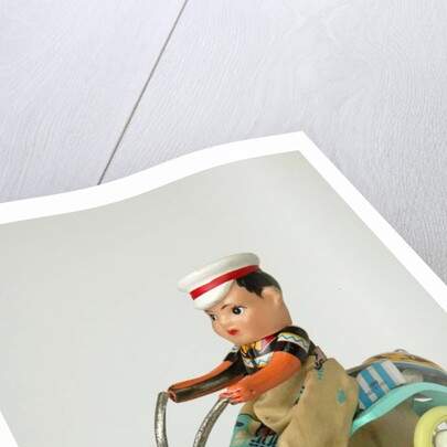 Clockwork toy boy on a tricycle by Unknown
