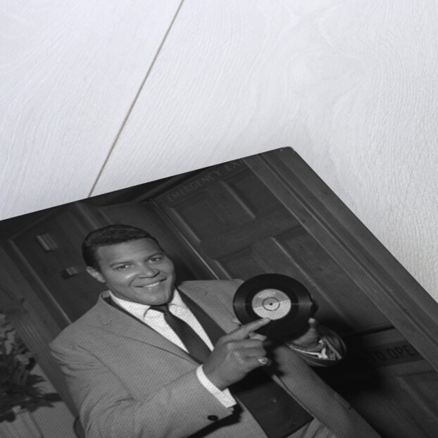 Chubby Checker holding a record by Harry Hammond