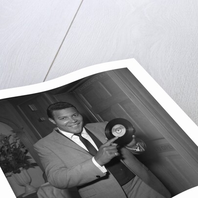 Chubby Checker holding a record by Harry Hammond