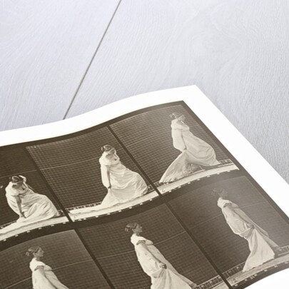 Woman picking up the hem of her dress by Eadweard Muybridge