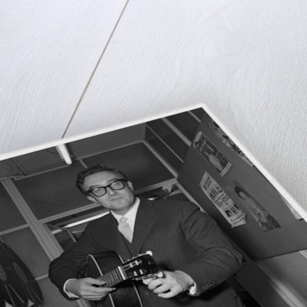 Peter Sellers holding a guitar by Harry Hammond