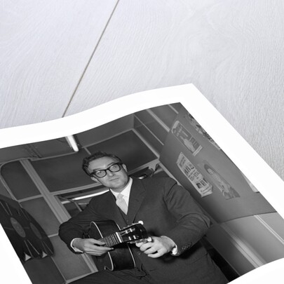 Peter Sellers holding a guitar by Harry Hammond