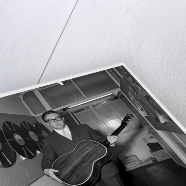 Peter Sellers holding a guitar by Harry Hammond