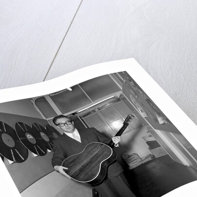 Peter Sellers holding a guitar by Harry Hammond