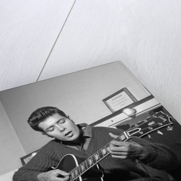 Cliff Richard playing his guitar by Harry Hammond
