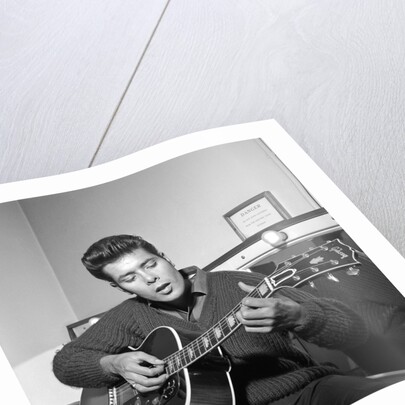 Cliff Richard playing his guitar by Harry Hammond