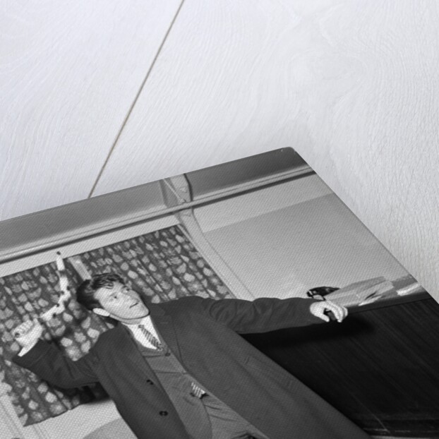 Cliff Richard playing with a boomerang by Harry Hammond
