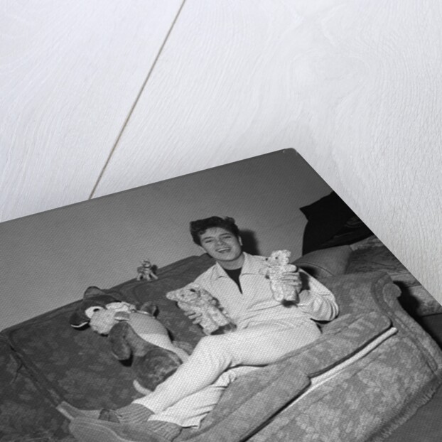 Cliff Richard on a sofa with soft toys by Harry Hammond