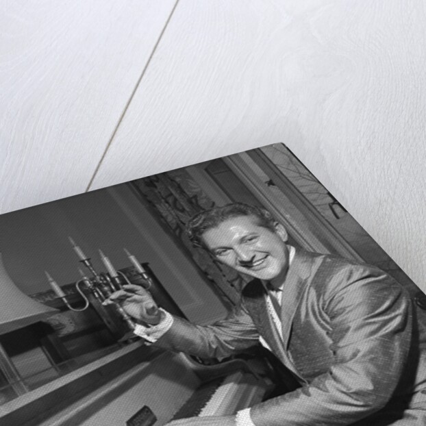 Liberace playing the piano at the Savoy Hotel by Harry Hammond