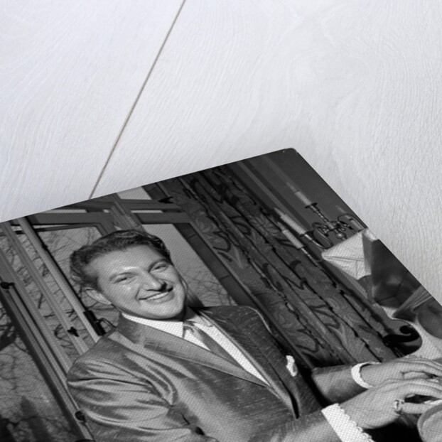 Liberace playing the piano at the Savoy Hotel by Harry Hammond