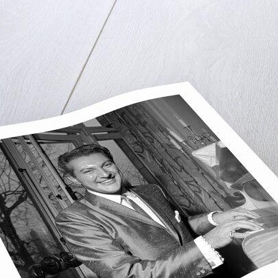 Liberace playing the piano at the Savoy Hotel by Harry Hammond