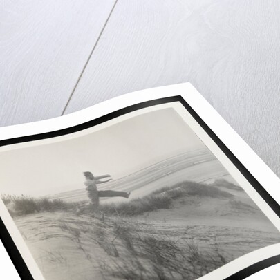 Man jumping off sand dune by Curtis Moffat