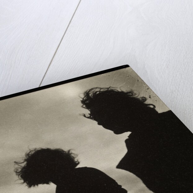 Silhouette of two women hair blown by wind sitting in wooden boat by Curtis Moffat