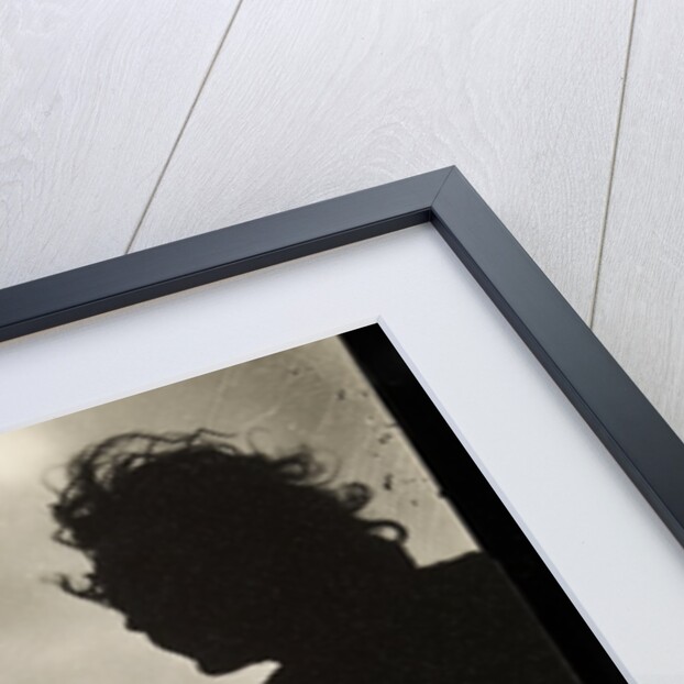 Silhouette of two women hair blown by wind sitting in wooden boat by Curtis Moffat