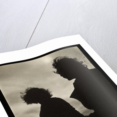 Silhouette of two women hair blown by wind sitting in wooden boat by Curtis Moffat