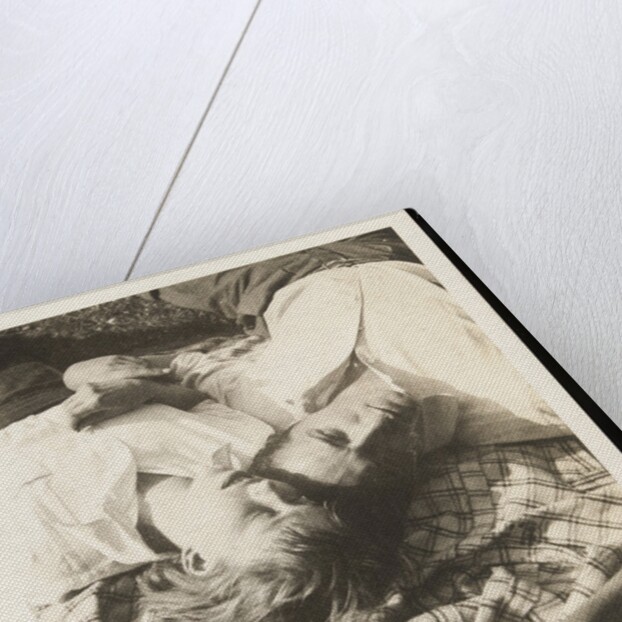 Man and woman lying head by head on rug on grass by Curtis Moffat
