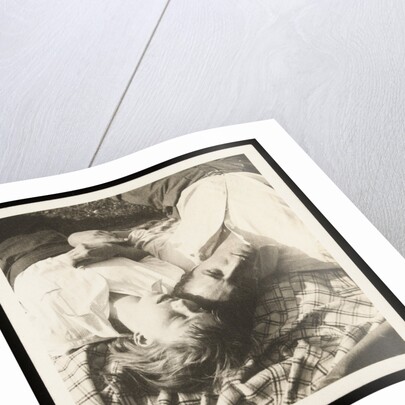 Man and woman lying head by head on rug on grass by Curtis Moffat