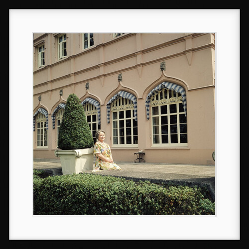 Queen Elizabeth, The Queen Mother sitting in the gardens at Windsor Great Park by Cecil Beaton