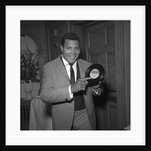 Chubby Checker holding a record by Harry Hammond