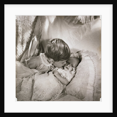 Prince Charles at the age of 18 months, kissing baby Princess Anne by Cecil Beaton