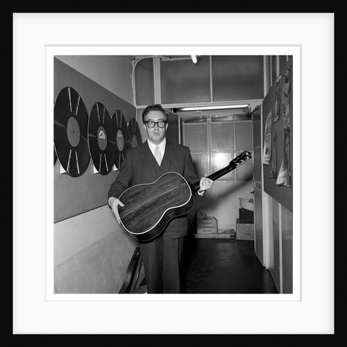 Peter Sellers holding a guitar by Harry Hammond