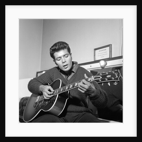 Cliff Richard playing his guitar by Harry Hammond