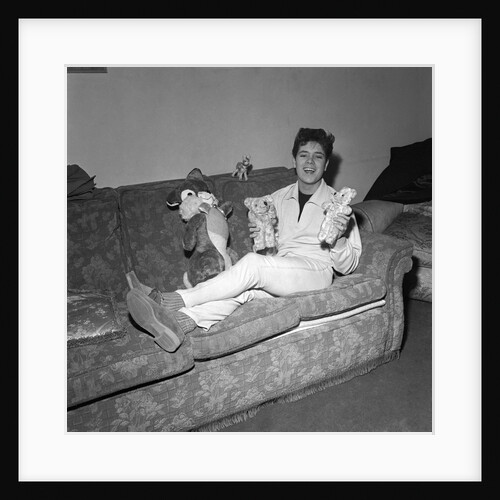 Cliff Richard on a sofa with soft toys by Harry Hammond