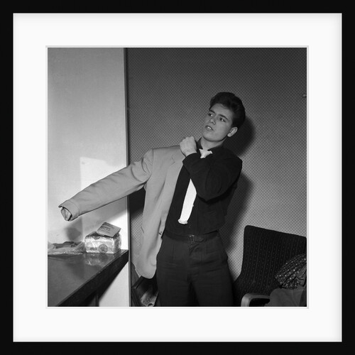 Cliff Richard putting his jacket on by Harry Hammond