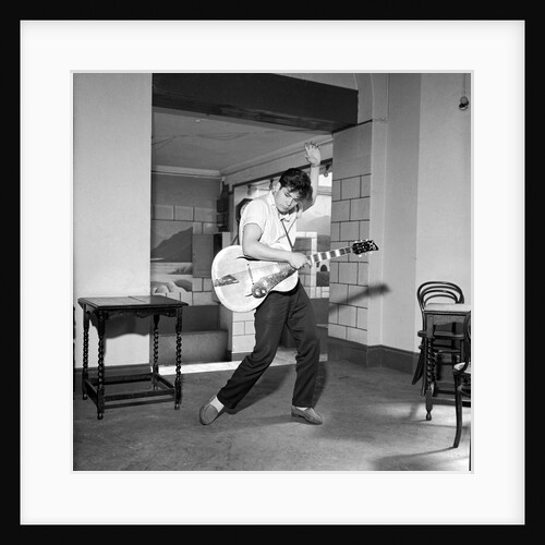 Cliff Richard playing the guitar by Harry Hammond