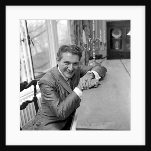 Liberace seated at the piano at the Savoy Hotel by Harry Hammond