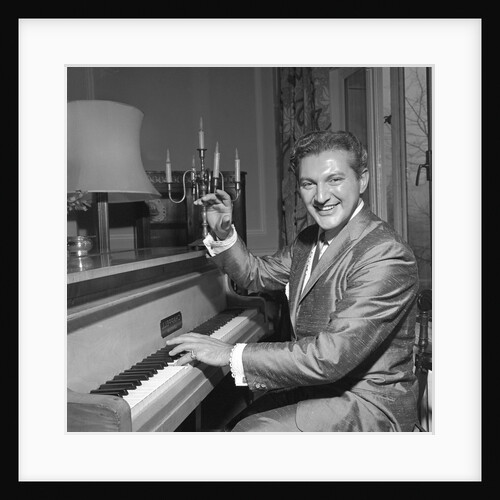 Liberace playing the piano at the Savoy Hotel by Harry Hammond