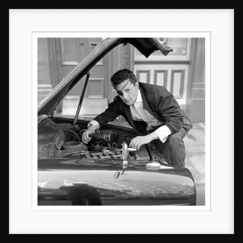 Johnny Kydd fixing the engine of his car by Harry Hammond