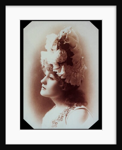 Belle Bilton wearing an ornate hat by Alexander Bassano
