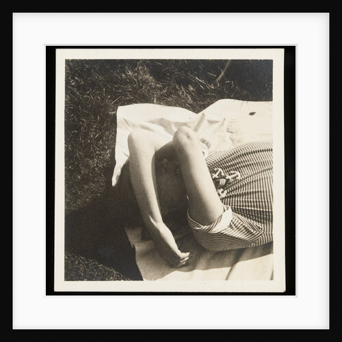 Woman wearing striped t-shirt lying on rug with both arms covering face by Curtis Moffat