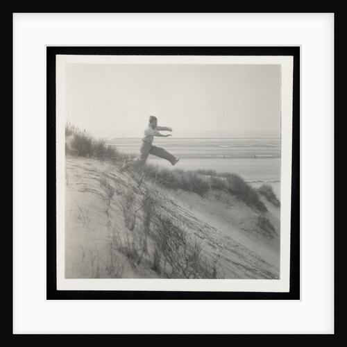 Man jumping off sand dune by Curtis Moffat