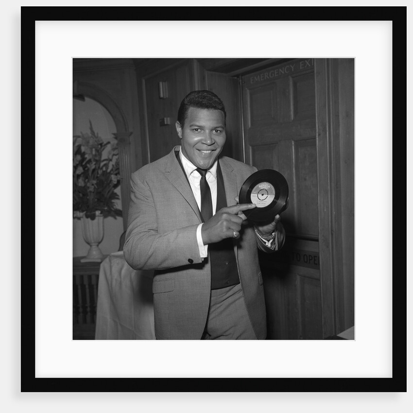 Chubby Checker holding a record by Harry Hammond