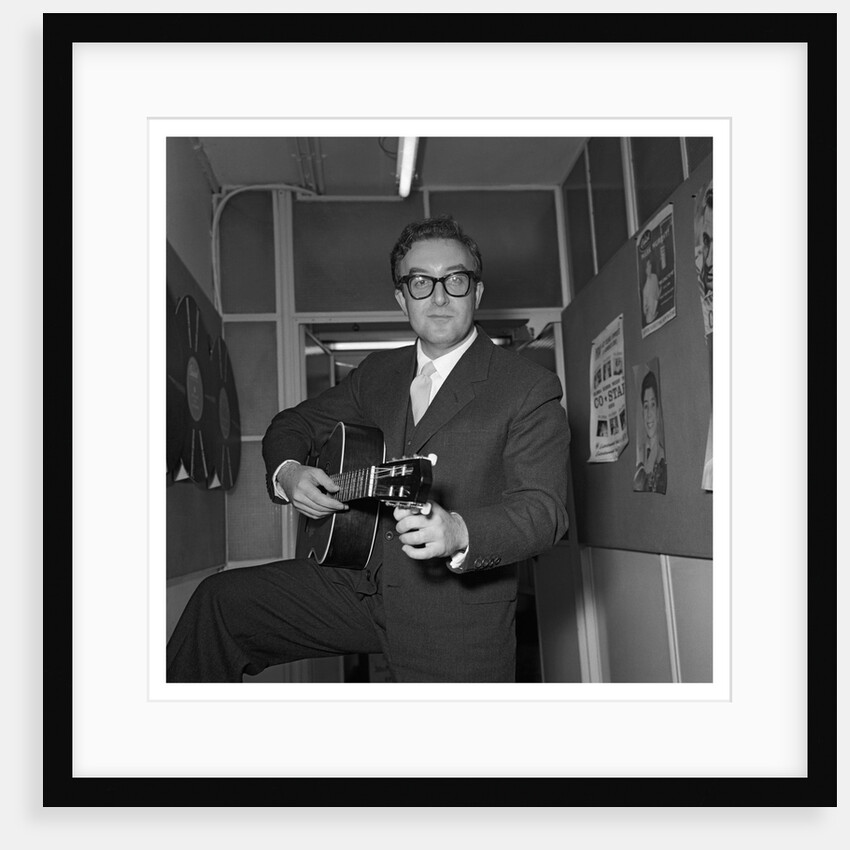 Peter Sellers holding a guitar by Harry Hammond