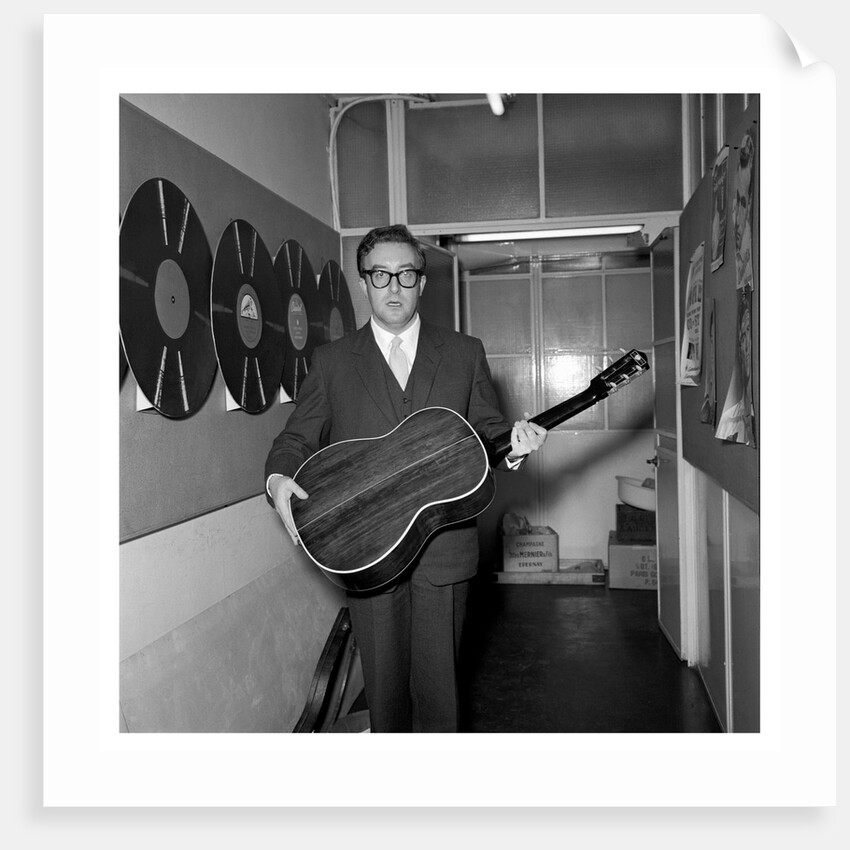 Peter Sellers holding a guitar by Harry Hammond