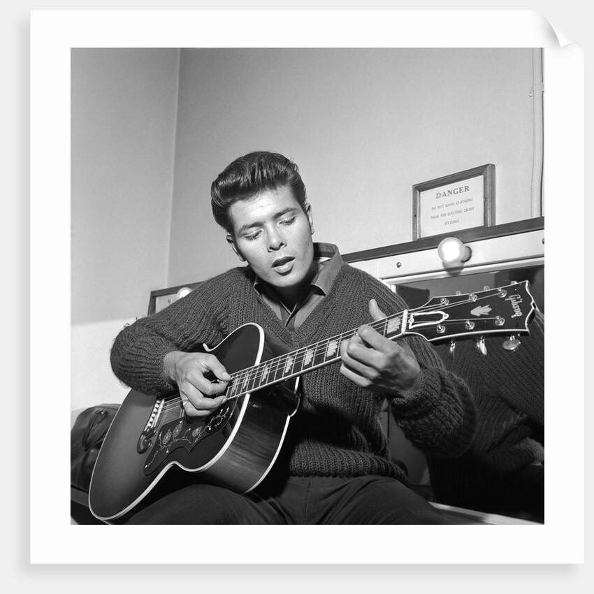 Cliff Richard playing his guitar by Harry Hammond